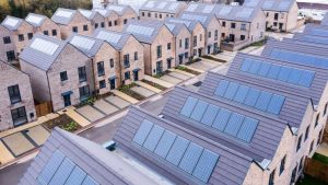 Aerial view of rows of new build modular terraced houses in the UK with characterless design for first time buyers