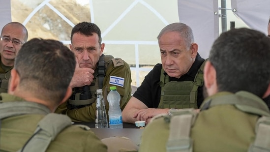 This handout picture released by the Government Press Office (GPO) shows Israel's Prime Minister Benjamin Netanyahu (R), Defence Minister Israel Katz (R) and army Chief-of-Staff Herzi Halevi (2nd L) during a briefing in the Netzarim Corridor, on November 19, 2024.(AFP)