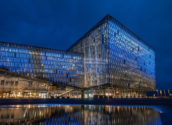 The modern Harpa Concert Hall in Reykjavik harbor during blue hour