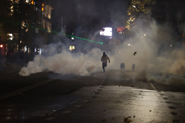 TBILISI, GEORGIA - DECEMBER 2: Police disperse water and gas at protesters gathering to protest against Prime Minister Irakli Kobakhidze on the decision to suspend Georgia's EU accession negotiations until 2028 on December 2, 2024 in Tbilisi, Georgia. Police used water cannons to disperse protesters who surrounded the front of the parliament building, throwing fireworks and various objects during the protests which entered the fourth day. (Photo by Davit Kachkachishvili/Anadolu via Getty Images)