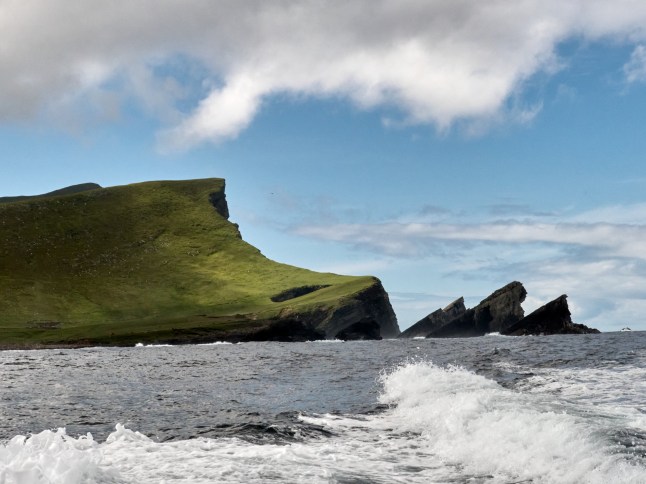 Gaada Stack is a double arch on the northern end of the Scottish Island of Foula, sitting next to the 2nd highest cliffs in the United Kingdom. Seen from the sea Foula is located in the Shetland archipelago of Scotland and one of the United Kingdom's most remote permanently inhabited islands. Foula lies 28 kilometres west of Walls in Shetland. 38 people live on the island.