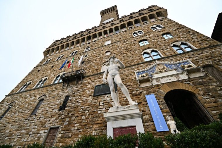 This photo shows a replica of Michelangelo's statue of David in front of the Palazzo Vecchio in the Piazza della Signoria, in the center of Florence, on December 19, 2024. (Photo by Andreas SOLARO / AFP) (Photo by ANDREAS SOLARO/AFP via Getty Images)