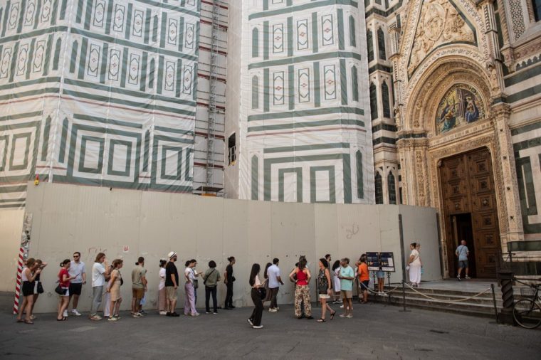 FIRENZE, ITALY - SEPTEMBER 01: Tourists queuing to visit the Duomo of Santa Maria del Fiore in Florence on September 01, 2024 in Firenze, Italy. Florence is one of the main tourist destinations in Italy, considered an open-air museum for the presence of artistic, cultural and historical sites. The city of Florence is the fourth in Italy for tourist presence, with over 7 million people passing through the accommodation facilities. The Uffizi and Accademia galleries are respectively the second and fourth Italian sites with the most visitors. (Photo by Ivan Romano/Getty Images)