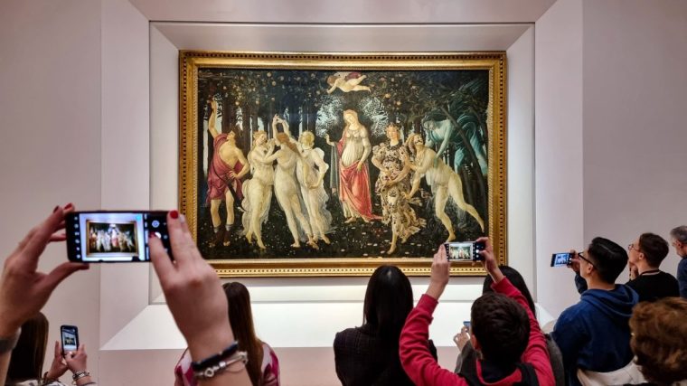 FLORENCE, ITALY - DECEMBER 30: Visitors view and photograph the painting Primavera (Spring) by the 15th century Italian Renaissance artist Sandro Botticelli at the Uffizi Gallery on December 30, 2022 in Florence, the capital of Italy???s Tuscany region. The 16th century museum is famous for its collection of ancient sculptures and its paintings that date from the Middle Ages to the Modern period. (Photo by David Silverman/Getty Images)