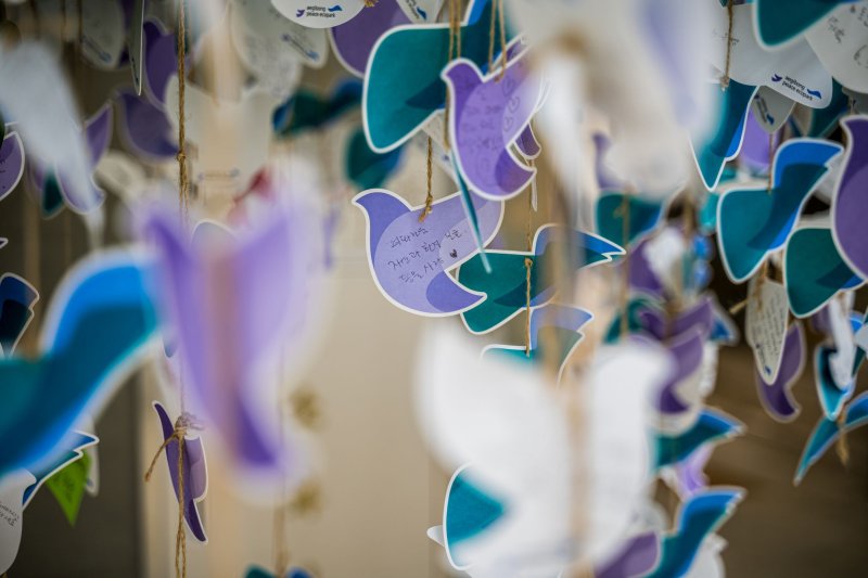Messages of peace written by visitors hang from a tree in the exhibition center of Aegibong Peace Ecopark in Gimpo, South Korea, in February. File Photo by Thomas Maresca/UPI