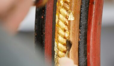 Conservator Matthias Manzini uses a gilding brush made from squirrel hair to apply the delicate gold leaf to the carriage wheel he is restoring (Alex HALADA)