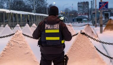 A policeman stands next to pyramidal anti-tank obstacles, at the Estonian-Russian border in Narva (Marko Mumm)