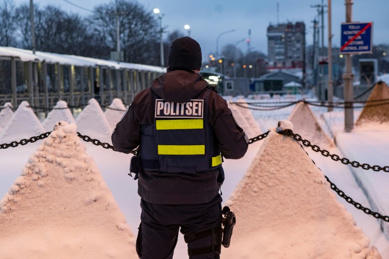 A policeman stands next to pyramidal anti-tank obstacles, at the Estonian-Russian border in Narva (Marko Mumm)