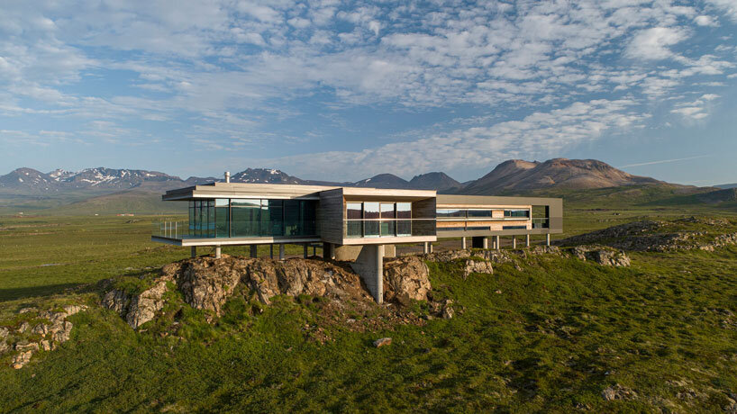 gudmundur jonsson's casa G rests on columns along mountainous icelandic landscape