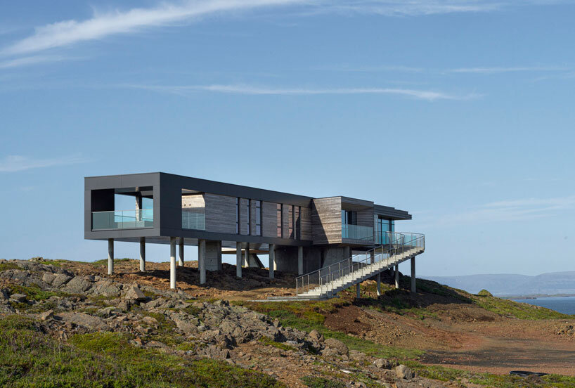 gudmundur jonsson's casa G rests on columns along mountainous icelandic landscape