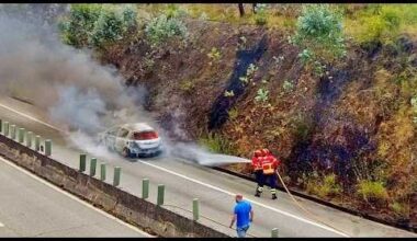 Portuguese firefighters putting out a vehicle fire before it starts a forest fire