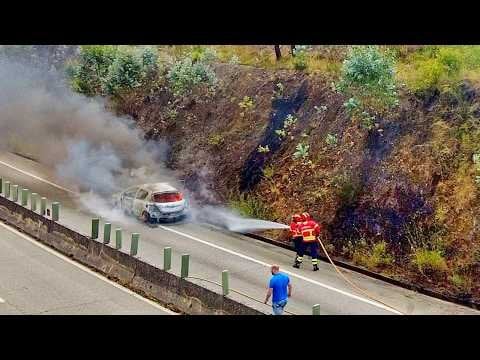 Portuguese firefighters putting out a vehicle fire before it starts a forest fire