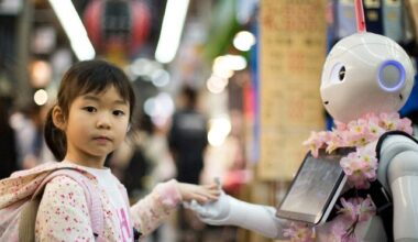 Young girl puts her hand into a robot's.