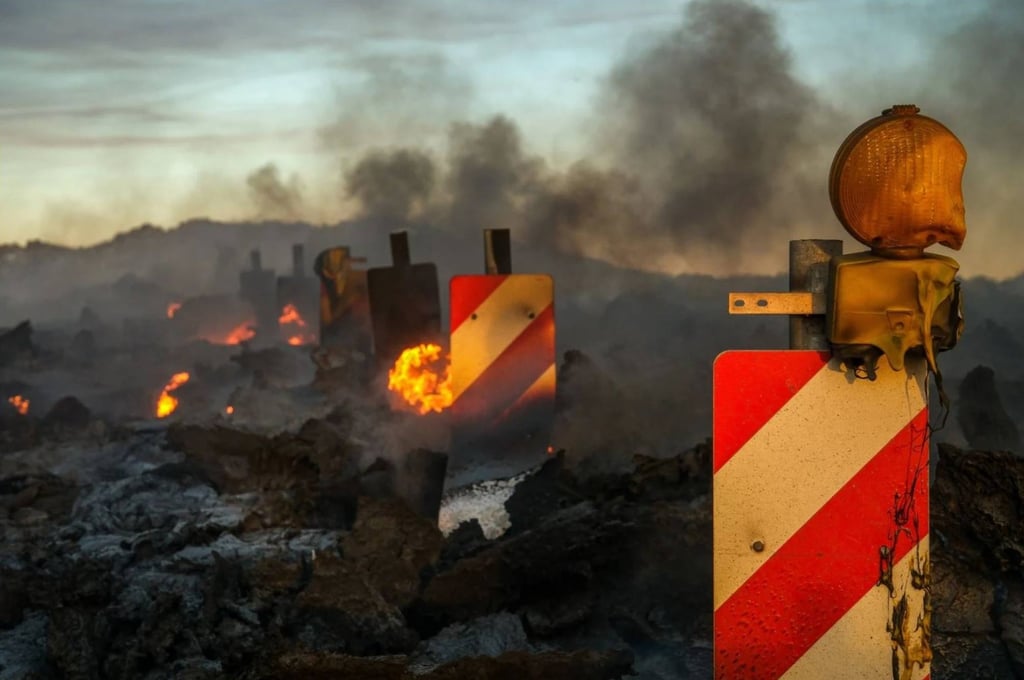 Traffic signs melt as lava flows over a road during a volcanic eruption near Grindavík. Photo: EPA-EFE Traffic signs melt as lava flows over a road during a volcanic eruption near Grindavík. Photo: EPA-EFE