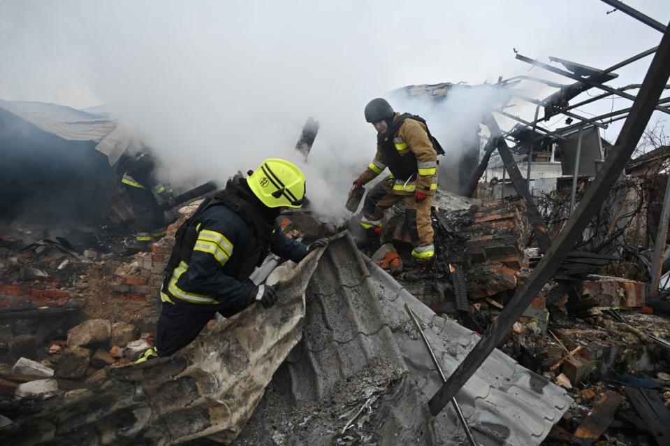 Rescuers of Ukraine’s State Emergency Service work to put out a fire in a private house after a drone strike in Kharkiv (Sergey Bobok/AFP via Getty Images)