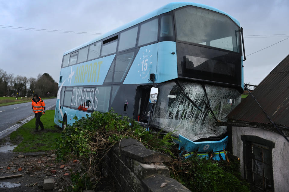 BALLYCLARE, NORTHERN IRELAND - DECEMBER 7: An airport transfer bus is pictured after leaving the road and crashing into a house in Templepatrick during high winds on December 7, 2024 in Ballyclare, Northern Ireland. Storm Darragh is the fourth named storm of this season and is expected to bring gusts of wind up to 80mph and heavy rain through the weekend. (Photo by Charles McQuillan/Getty Images)