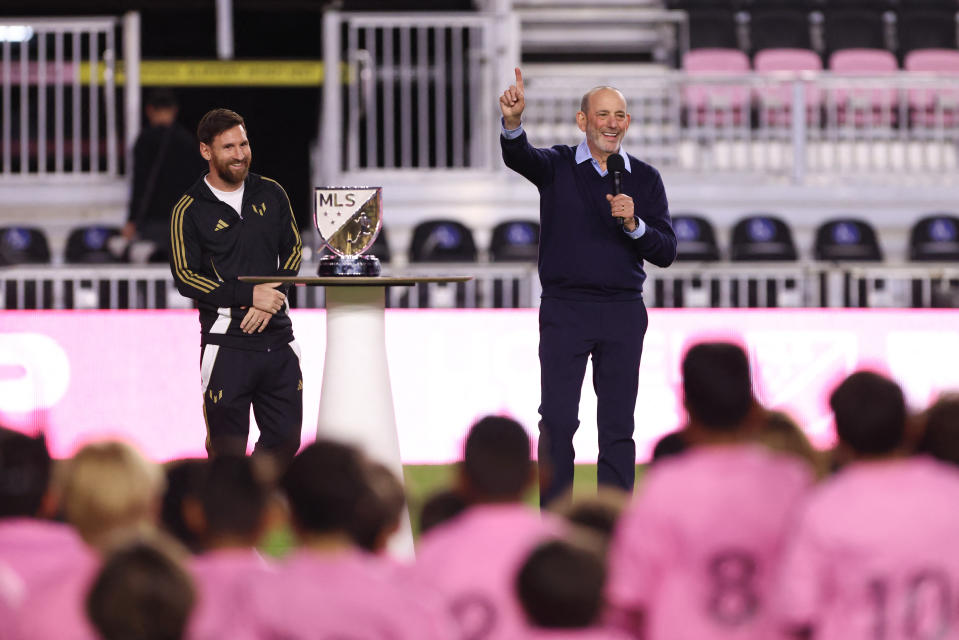 Dec 4, 2024; Ft. Lauderdale, Florida, USA; Inter Miami CF forward Lionel Messi (10) and MLS commissioner Don Garber talk to Inter Miami CF academy players during the presentation of the Landon Donovan MVP award at Chase Stadium. Mandatory Credit: Sam Navarro-Imagn Images