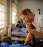Harry clutches a patient's hand in one snap