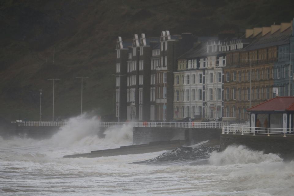 Aberystwyth Wales UK weather December 7th 2024 storm DARRAGH batters the west coast of Wales with a red warning in place gusts of up to 90mph hit hard causing havoc with power lines down and many thousands left without electricity. Large waves crash over the promenade and sea defences, with flying debris that could lead to injury or danger to life. Credit: mike davies/Alamy Live News
