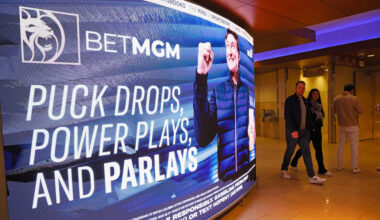 Fans walk past a BetMGM sign featuring Wayne Gretzky.