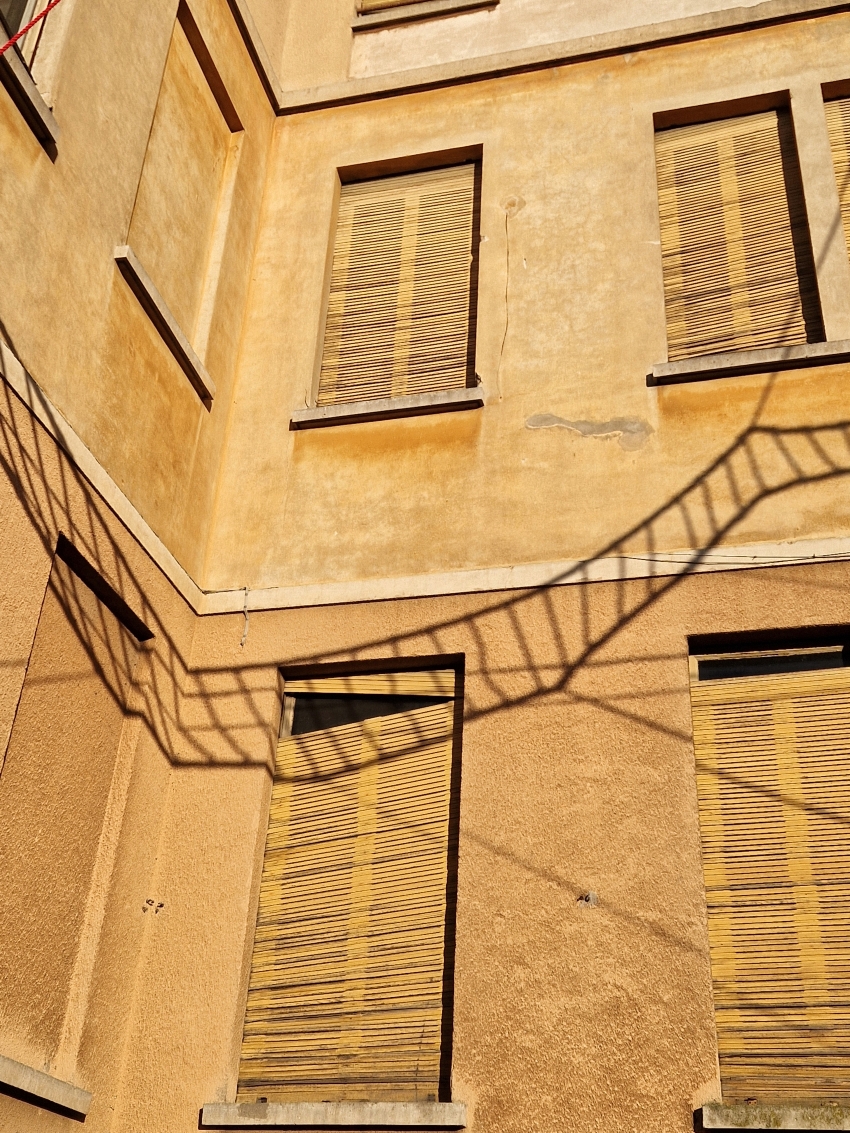 la cura threaded installation by ECO weaves across neglected elementary school in italy