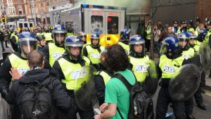 Police in riot gear confront protesters in central London during large a anti government rally on March 26, 2011 in London, UK. Arrests were made after protesters clashed with police across the city.