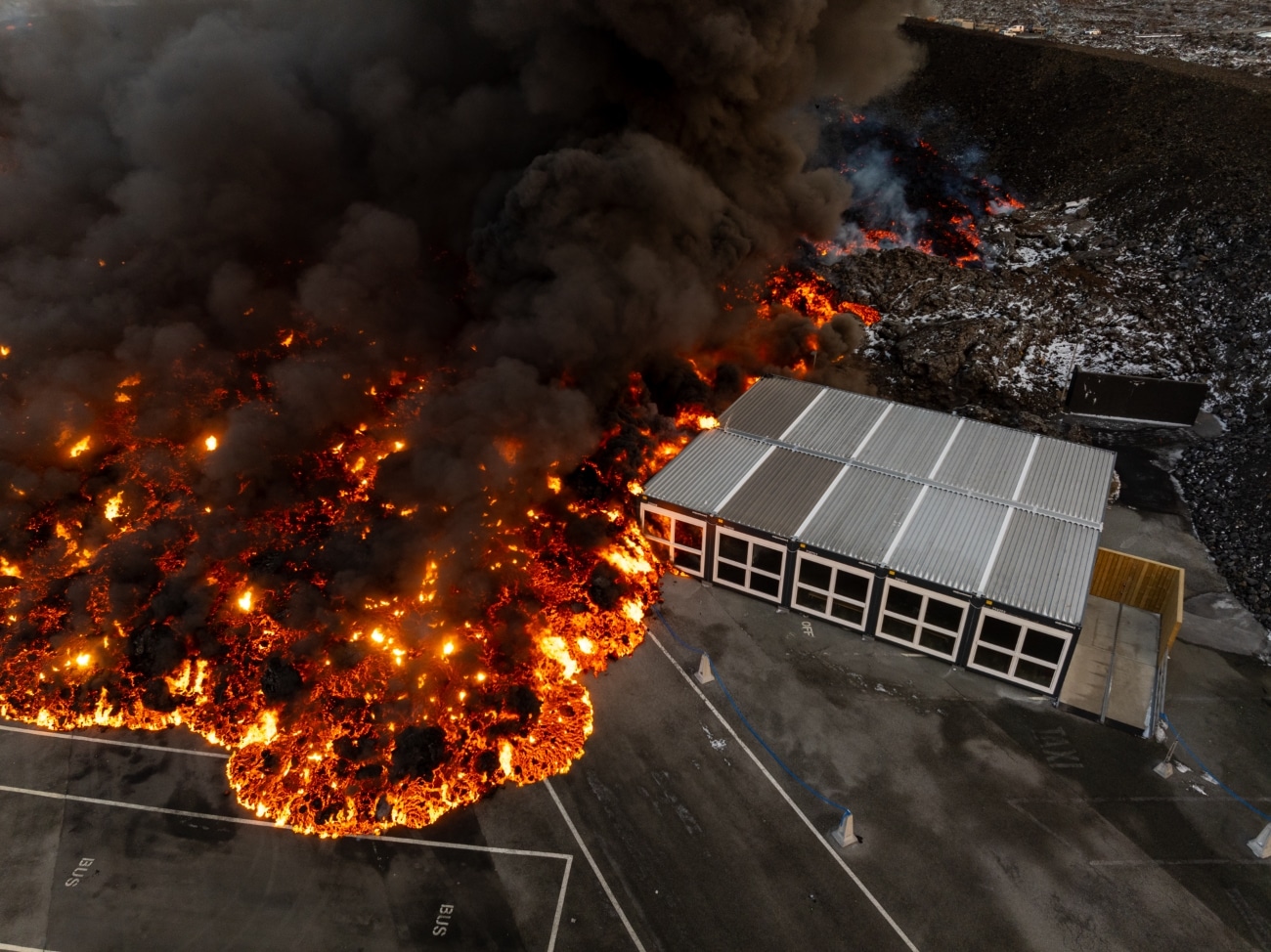 Lava running over service house on the parking lot of Blue Lagoon
