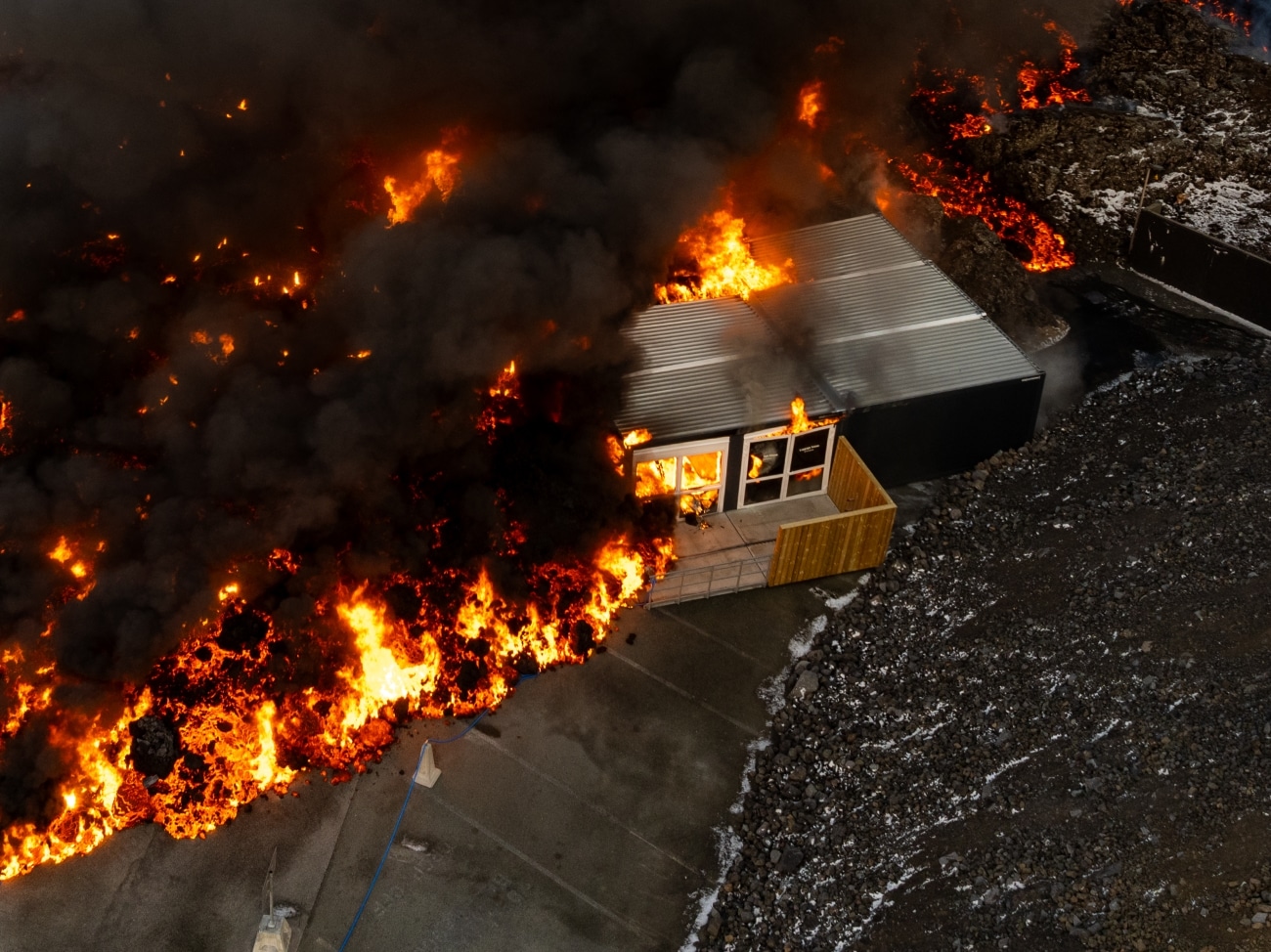 Lava running over service house on the parking lot of Blue Lagoon