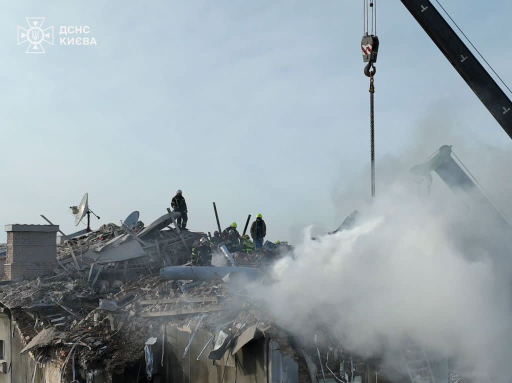 Ukrainian rescuers working at the site of a drone attack on a residential building in Kyiv, Ukraine, 01 January 2025. STATE EMERGENCY SERVICE HANDOUT/EPA-EFE/Shutterstock