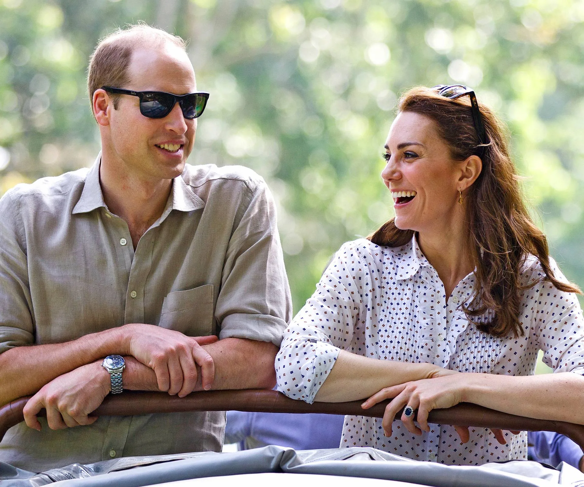 William and Kate leaning on a wooden bar beside each other