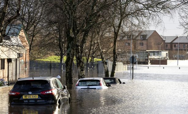 Cars are completely submerged following a night of heavy rain on New Year's Eve