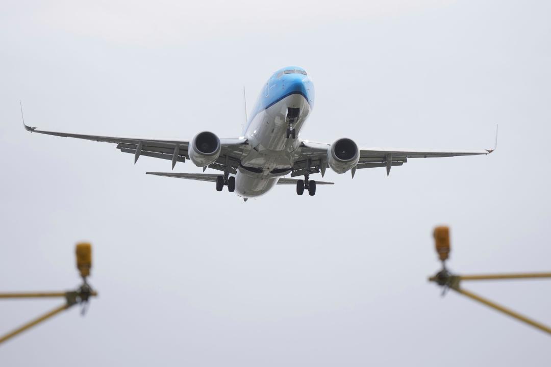 A plane lands in gusty conditions at Heathrow Airport on Friday. (AP)