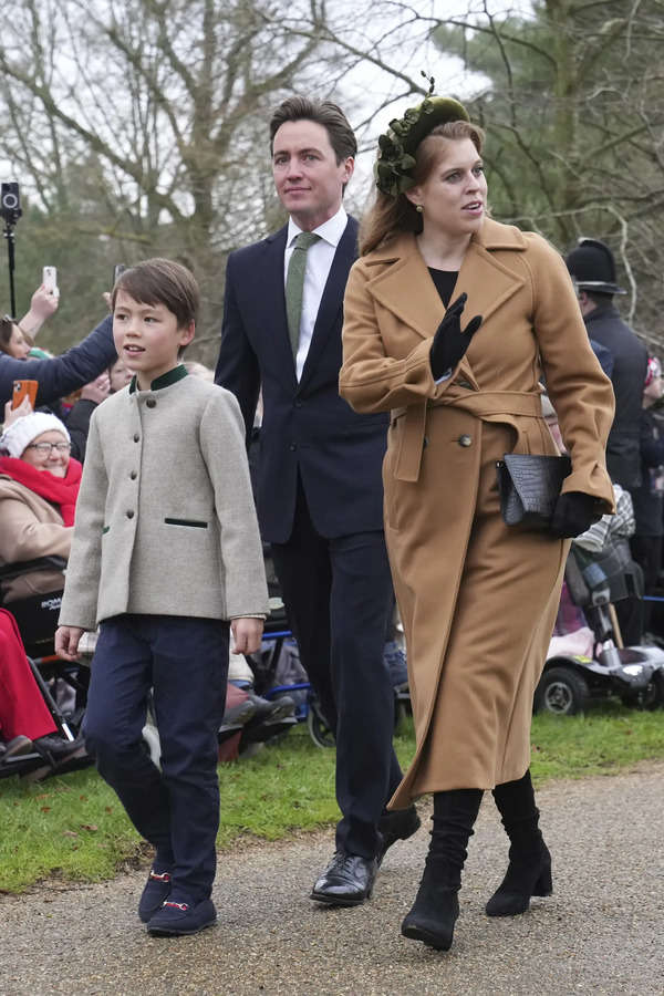 Princess Beatrice waves at the crowds with her husband Edoardo Mozzi and her stepson Christopher Wolf as they arrive for the Christmas day service at St Mary Magdalene Church in Sandringham in Norfolk, England, Wednesday, Dec. 25, 2024. (AP Photo/Jon Super) Britain Royals Christmas