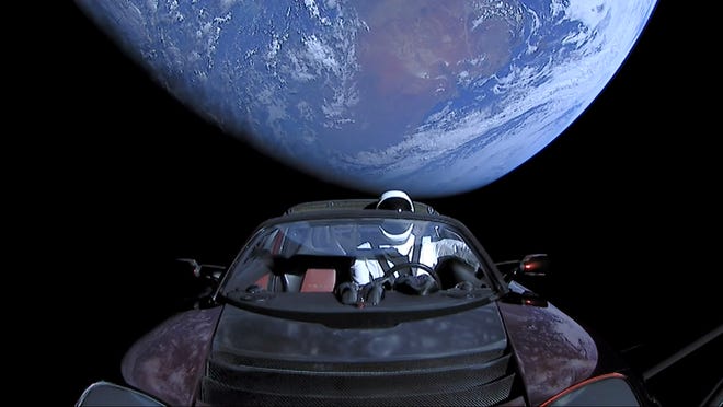 In this 2018 handout photo provided by SpaceX, a Tesla Roadster launched from the Falcon Heavy rocket with a dummy driver named "Starman" heads towards Mars.