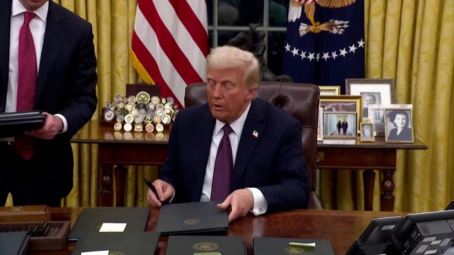 President Donald Trump signing executive orders