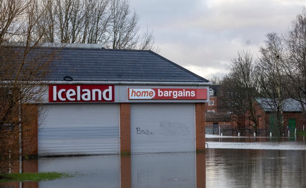 Home Bargains and Iceland in Wigan are submerged following a night of heavy rain on New Year's Eve