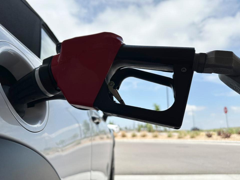 A motorist fills up at a gasoline pump.