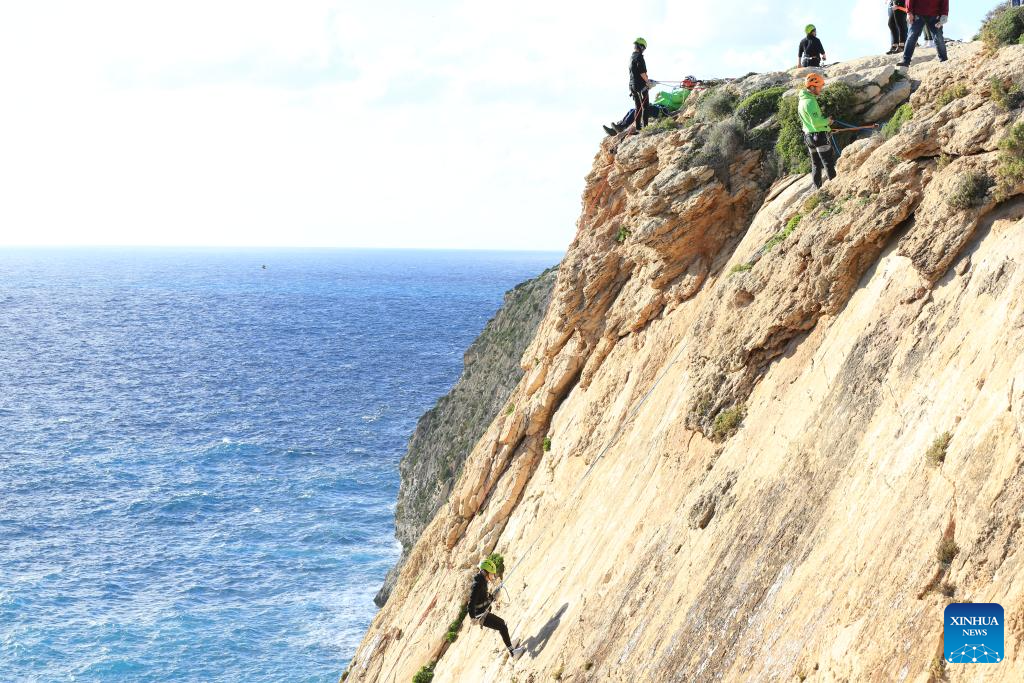People abseil at Xaqqa Valley in Malta-Xinhua