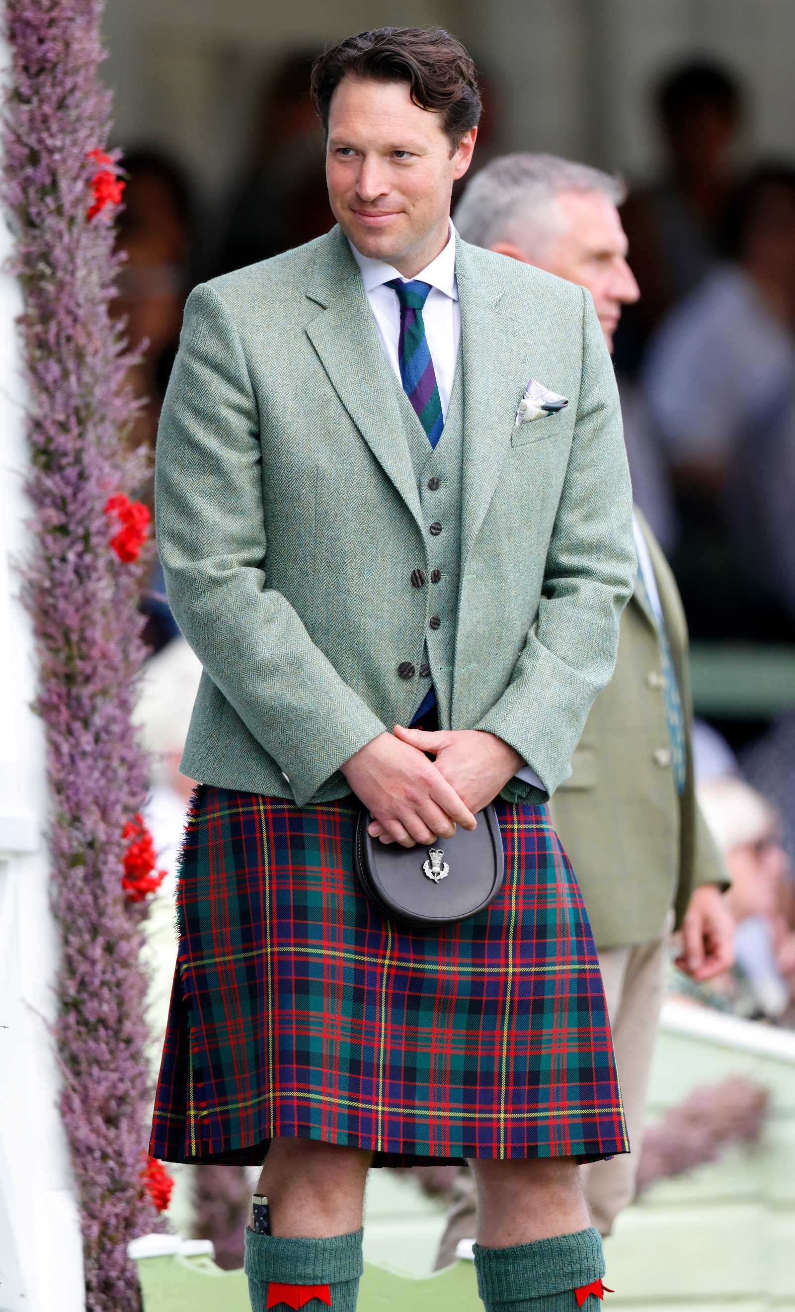 Image may contain Clothing Skirt Tartan Accessories Formal Wear Tie Adult Person Kilt Bag Handbag and Child