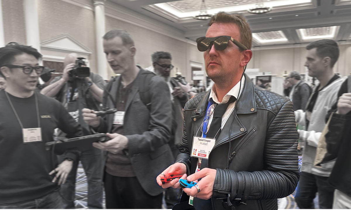 Image of a handsome man (Daniel Cooper) wearing Xreal One Pro AR Glasses while playing a Nintendo Switch.
