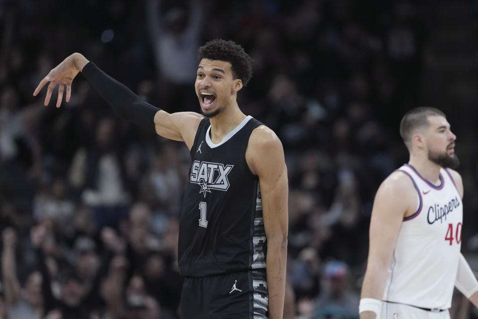 San Antonio Spurs center Victor Wembanyama (1) reacts to a score against the LA Clippers during the second half of an NBA basketball game in San Antonio, Wednesday, Jan. 29, 2025. (AP Photo/Eric Gay)