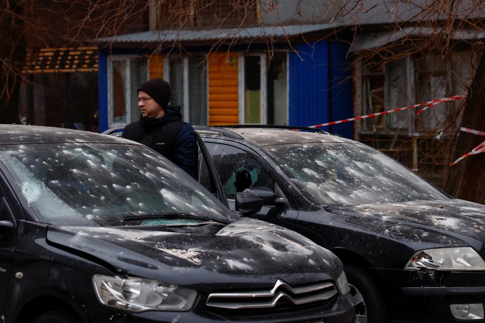 A resident inspects his car damaged after a Russian drone strike on Ukraine (REUTERS)