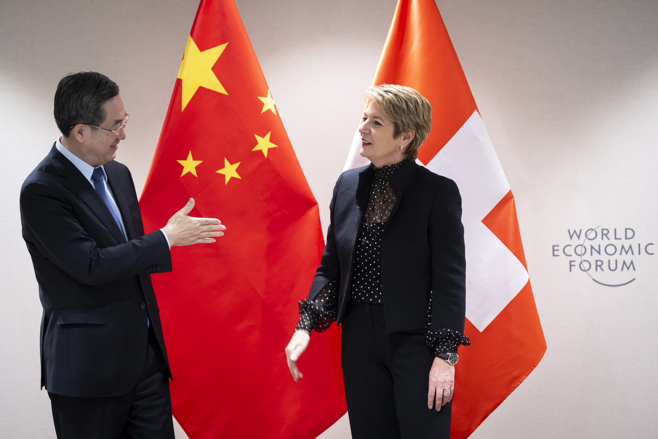 Ding Xuexiang, Vice-Premier of the People's Republic of China, left, and Swiss Federal President Karin Keller-Sutter, right, shakes hands after a bilateral meeting on the sideline of the 55th annual meeting of the World Economic Forum, WEF, in Davos, Switzerland, Tuesday, January 21, 2025.