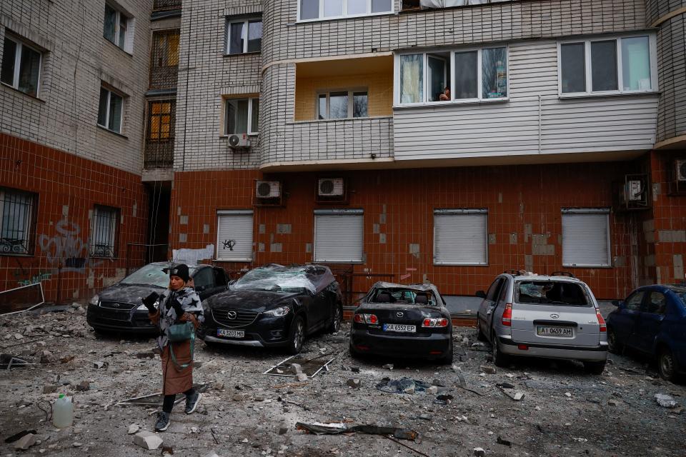 A resident walks next to cars damaged during a Russian drone strike, amid Russia's attack on Ukraine (REUTERS)