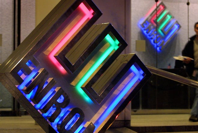 Enron employees leave the headquarters building in 2002 in downtown Houston, Texas. The company appears to have been relaunched as of Dec. 2, 2024 as an elaborate joke more than 20 years after it went bankrupt.