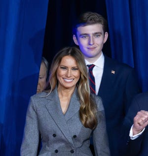 Donald Trump, accompanied by his wife Melania Trump, and son Barron Trump, enters his Election Night Watch Party at the Palm Beach County Convention Center at the Palm Beach County Convention Center on November 5, 2024.