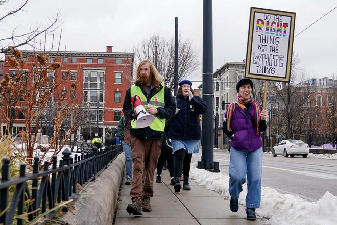 People march around the perimeter of Washington Park during a protest on Saturday against president-elect Donald Trump’s inauguration.