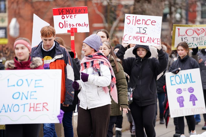 People march around the perimeter of Washington Park during a protest on Saturday against president-elect Donald Trump’s inauguration.