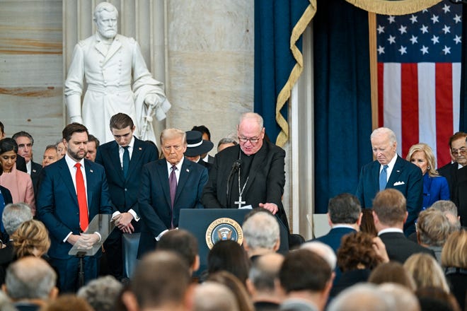 Vice President-elect JD Vance of Ohio, President-elect Donald J. Trump, and President Joe Biden listen while Cardinal Timothy Dolan speaks during the inauguration of Donald Trump as the 47th president of the United States takes place inside the Capitol Rotunda of the U.S. Capitol building in Washington, D.C., Monday, Jan. 20, 2025. It is the 60th U.S. presidential inauguration and the second non-consecutive inauguration of Trump as U.S. president.