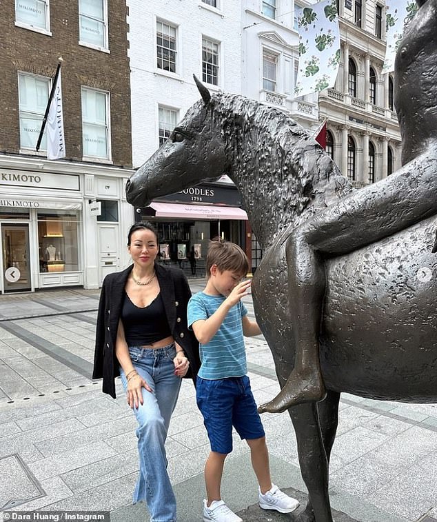 In one image, Dara, sporting a black blazer and matching vest, teamed with blue jeans, posed with her son, who was equally casually dressed, next to a statue of a horse